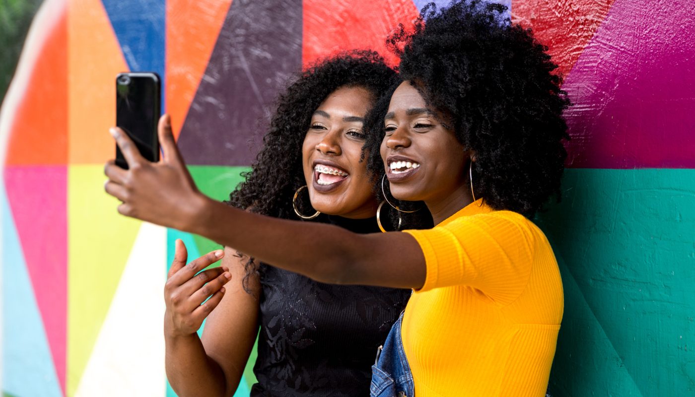 Afro women descent taking selfie photos in the park